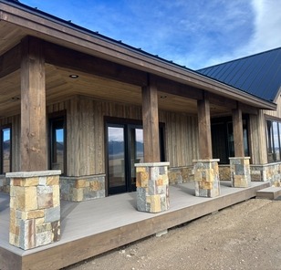 Big timber work, Montana stone, and low maintenance decking.