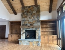 Koelzer Masonry laid native Montana stone on the fireplace with custom built-ins by SMCB.