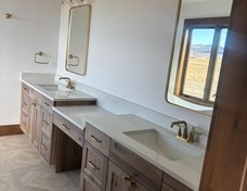 Master Bath: beautiful wood cabinets with gold hardware and parkay oak tile floor.