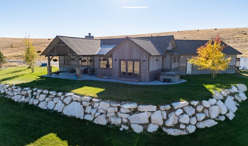 Custom home with retaining wall built from the land.