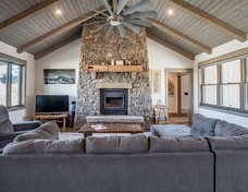 Japanese cedar t&g ceilings with timber accents. Flat Willow stone fireplace by Scott Koelzer Masonry