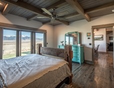 Master bedroom: wood ceiling with timber grid accents.