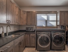 Large laundry room with gear built-ins.